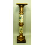 AN EDWARDIAN AESTHETIC DESIGN TORCHERE, ebonised and gilt wood, with hand coloured ceramic stem,