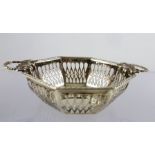 SYNYER & BEDDOES AN OCTAGONAL SILVER PIN/BONBON DISH having twin cast bow handles and fretted belly,