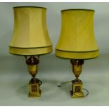 A PAIR OF 20TH CENTURY BRASS URN FORM TABLE LAMPS of classical form with handles, acanthus leaf