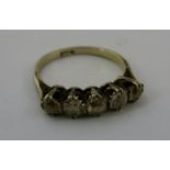 A GOLD COLOURED METAL DIAMOND FIVE STONE HALF HOOP RING having period cushion cut brilliants in