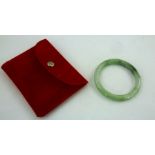 A 20TH CENTURY JADE BANGLE, interior diameter 5cm, in a red pouch