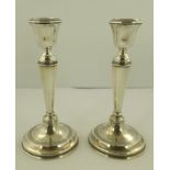 WILLIAM HUTTON AND SONS LTD A PAIR OF EARLY 20TH CENTURY SILVER CANDLESTICKS of Georgian design,