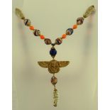 AN EGYPTIAN REVIVAL NECKLACE with hieroglyphic and marbled glass beads and a winged pharaoh pendant