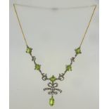 A VICTORIAN OLIVINE DIAMOND NECKLACE having bows, scrolls set with diamonds and six oval mixed cut