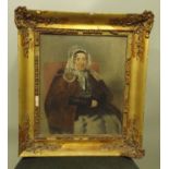 19TH CENTURY BRITISH SCHOOL A portrait of a lady wearing a bonnet, an Oil on board, see label verso,