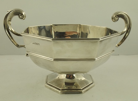WALKER AND HALL AN OCTAGONAL SILVER FRUIT BOWL with scroll handles, raised on platform base,