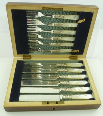 A SET OF DESSERT KNIVES AND FORKS FOR SIX having silver plated blades with mother of pearl