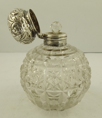 J. COLLYER LTD. A SILVER CAPPED SCENT BOTTLE having scrolled pressed decorated mushroom cap with