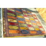 A MID 20TH CENTURY KASHMIR CARPET the field of multi mihrabs, varying colour grounds yellow, orange,