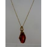 A POLISHED CABOCHON OPAL mounted in pendant frame stamped 14k, suspended on a 9ct gold chain