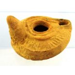 A ROMAN EARTHENWARE OIL LAMP, 2nd-5th AD, 8cm