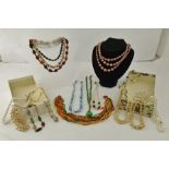 A COLLECTION OF SEVENTEEN VARIOUS COSTUME NECKLACES including; pearls and a green facetted bead with