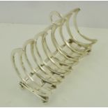 A SILVER PLATED CRESCENT MOON SECTION TOAST RACK, raised on bun feet, 13cm wide