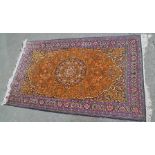 A PERSIAN WOOL/SILK MIX RUG of orange ground with stylised floral decoration, deeply blue and