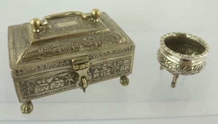 AN EASTERN WHITE METAL CASKET with chased landscape decoration, having hinged cover with swan neck