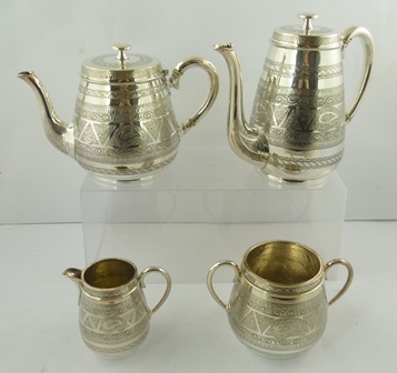 AN EDWARDIAN SILVER PLATED FOUR-PIECE TEA AND COFFEE SERVICE, having chased decoration, comprising a