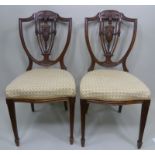 A PAIR OF MAPLE & CO. EDWARDIAN ROSEWOOD HEPPLEWHITE SHIELD BACK SALON CHAIRS, having carved crest