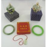 TWO JADE SLAVE BANGLES, and a carved jade Buddha PENDANT, boxed, together with two Chinese