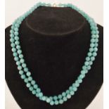 A FACETTED AQUA GLASS DOUBLE ROW NECKLACE of uniform beads with 9ct gold clasp, 48cm long