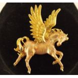 A KIRKS FOLLY GILT METAL BROOCH of Pegasus, approx 68mm x 50mm wide