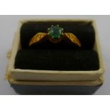 AN EMERALD SINGLE STONE 18CT GOLD RING having claw setting with provision for pearls, size N