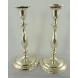 ELLIS & CO A PAIR OF GEORGE V SILVER CANDLESTICKS of classical form with baluster stems on