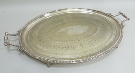 A LARGE GEORGIAN DESIGN SILVER PLATED TEA TRAY, oval with beaded rim and chased decoration, fitted