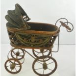 AN EARLY 20TH CENTURY PROBABLY FRENCH WICKER FRAMED DOLL'S PRAM on four metal clad wheels, 40cm long