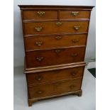 A GEORGE III OAK SECRETAIRE CHEST ON CHEST having brass handles and escutcheons, the top fitted