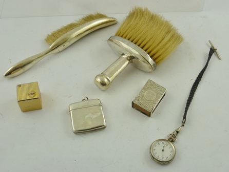 TWO SILVER CRUMB BRUSHES, a plain silver VESTA CASE, an engraved silver MATCH SLIDE, an early 20th