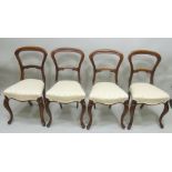 A SET OF FOUR VICTORIAN MAHOGANY DINING CHAIRS serpentine fronted seats, upholstered in patterned