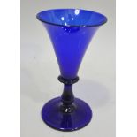 A 19TH CENTURY BLUE WINE GLASS, having trumpet bowl and baluster stem with circular platform foot