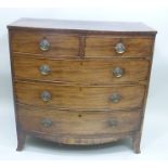 A 19TH CENTURY MAHOGANY BOW FRONT CHEST of two short over three long graduated drawers with brass