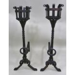 A PAIR OF WROUGHT IRON ELIZABETHAN DESIGN FIRE DOGS with basket, mounts and ring decoration, 77.