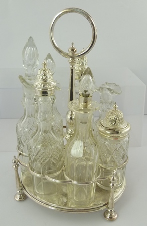 A 19TH CENTURY ELECTRO PLATE GEORGIAN STYLE SEVEN-BOTTLE CRUET, having central column and handle,