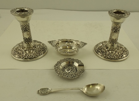 BLOW & CO A PAIR OF PRESSED DECORATED SILVER DWARF CANDLESTICKS each having worked integral