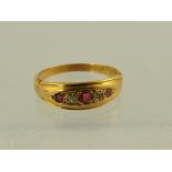 A GEORGE V 18CT GOLD RUBY AND DIAMOND DRESS RING having three rubies interset with two diamonds in a