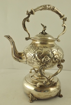 AN EPNS VICTORIAN STYLE KETTLE-ON-STAND, having repousse body, on a spun spirit holder