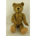 A 1930's BRITISH YELLOW PLUSH TEDDY BEAR having seamed head, re-threaded nose and pads, 40cm high