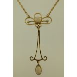 AN EDWARDIAN GOLD OPAL SET WIRE PENDANT having two cabochon opals and seed pearls on a bar and