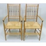 A PAIR OF ARTS AND CRAFTS DESIGN SUSSEX STYLE OPEN ARM COUNTRY CHAIRS, each having turned spindle