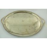 WALKER & HALL AN OVAL SILVER DRINKS TRAY, the centre monogrammed "W" and having cast and applied