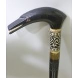 AN EARLY 20TH CENTURY INDIAN SWORD STICK, having ebonised shaft with stylised bird head handle