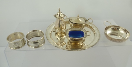 A STERLING SILVER THREE-PIECE CONDIMENT SET, a beaded rim WAITER, 16cm diameter, two silver NAPKIN