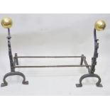 A PAIR OF ELIZABETHAN DESIGN IRON FIRE DOGS with brass sphere mounts, 78cm high, together with loose