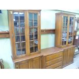 A LATE 20TH CENTURY OAK FINISHED GEORGIAN STYLE CABINET BOOKCASE having two section