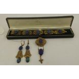 MAX NEIGER A GILT METAL SUITE comprising; bracelet, earrings and brooch with pendant drops, with