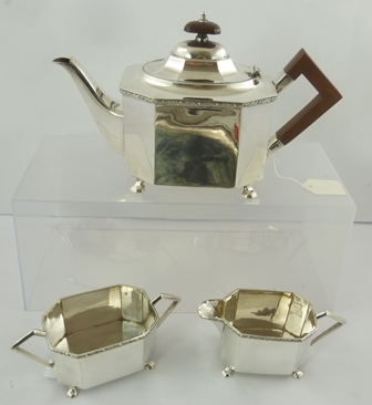 AN EPNS THREE PIECE TEA SET of elongated octagonal form with applied wire banding and plain body,