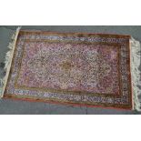 A PERSIAN SILK RUG, having cream central panel with multi-colour stylised floral decoration,