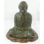 A 20TH CENTURY CAST AND PATINATED JAPANESE BRONZE BUDDHA in traditional Lotus pose with associated